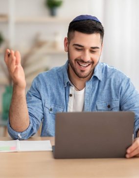 smiling-israeli-man-working-on-laptop-computer-at-2021-09-03-14-19-32-utc.jpg